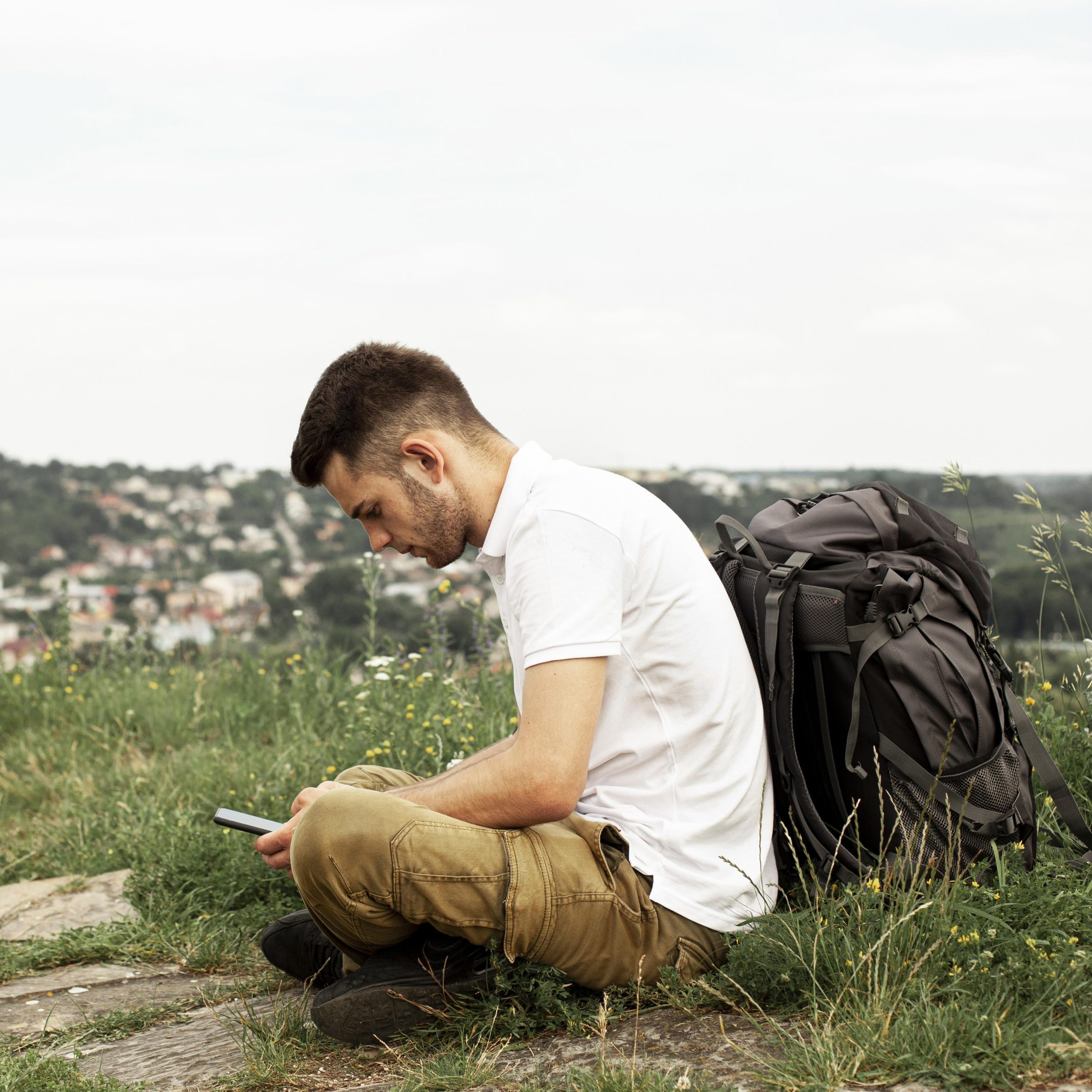 man-with-backpack-checking-mobile